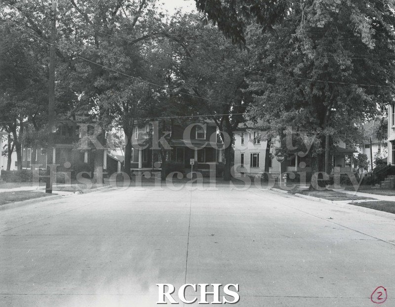 Black and white photograph of Locust Street with houses in the background.