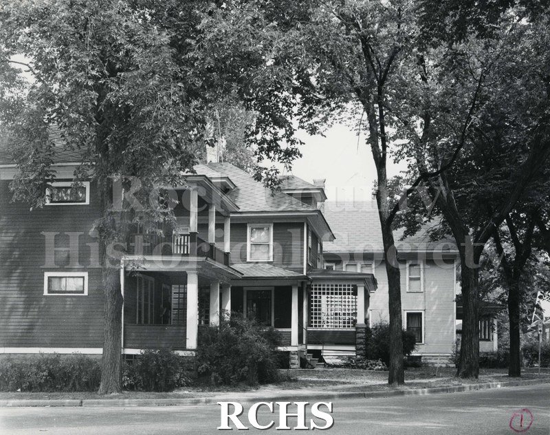 Black and white photograph of the corner of Court and Locust Streets with houses in the background.