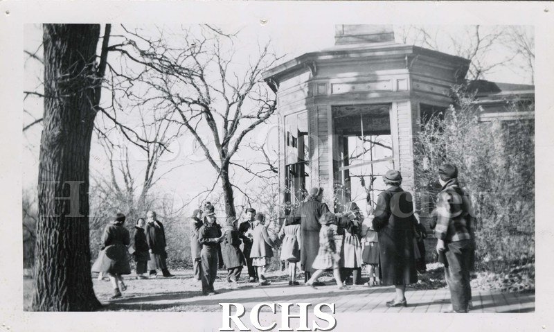 Black and white photograph of J. B. Crosby House; then Oaklawn City Hospital. Shows a building with several people standing in front of it.