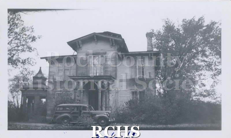 Black and white photograph of J. B. Crosby House. Shows a two story house set among trees. There are is a car parked in front of the house. On bottom: "10-6-1949".