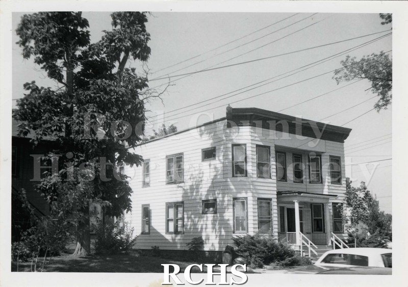 Black and white photograph of 314 McKinley Street, a two story building with a flat roof.