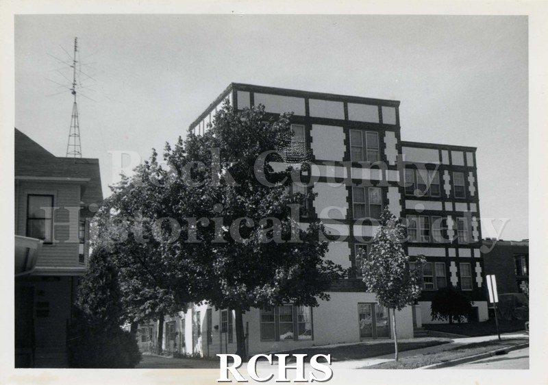 Black and white photograph of 419-421 E. Milwaukee Street, a four story building with a decorative stucco exterior.