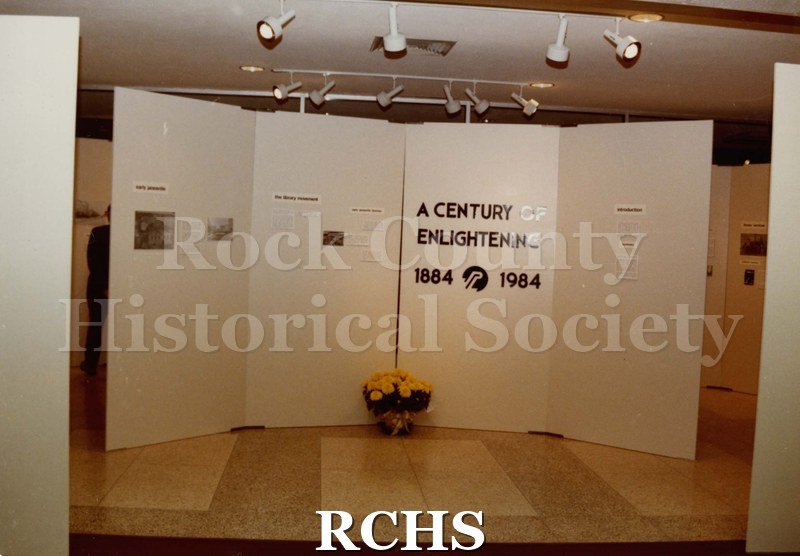 Colored photograph of the Janesville Public Library Centennial Exhibit Installation.