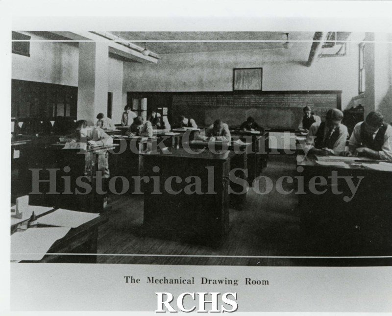 Black and white photograph of the Janesville High School Mechanical Drawing Room (as stated on photo) with students at work. Written on reverse: "1925 Phoenix".