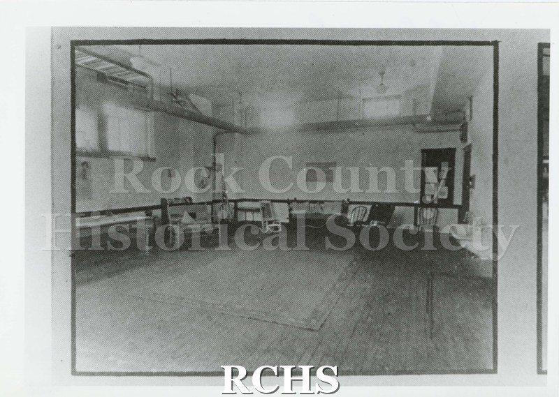Black and white photograph of the Girl Reserve Room Janesville High School 1924. Shows a large open room with sinks and seating lining perimeter.