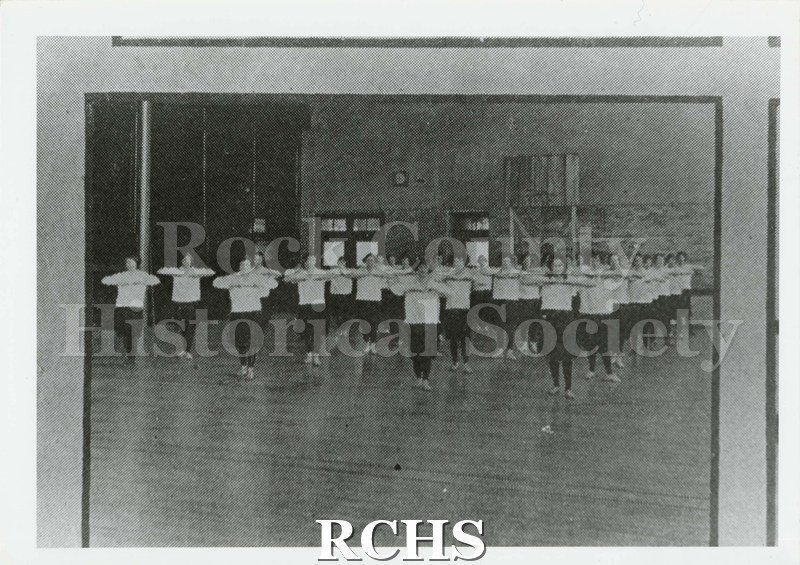Black and white photograph of girls in Janesville High School gymnasium 1924 dressed in exercise clothing of the period.