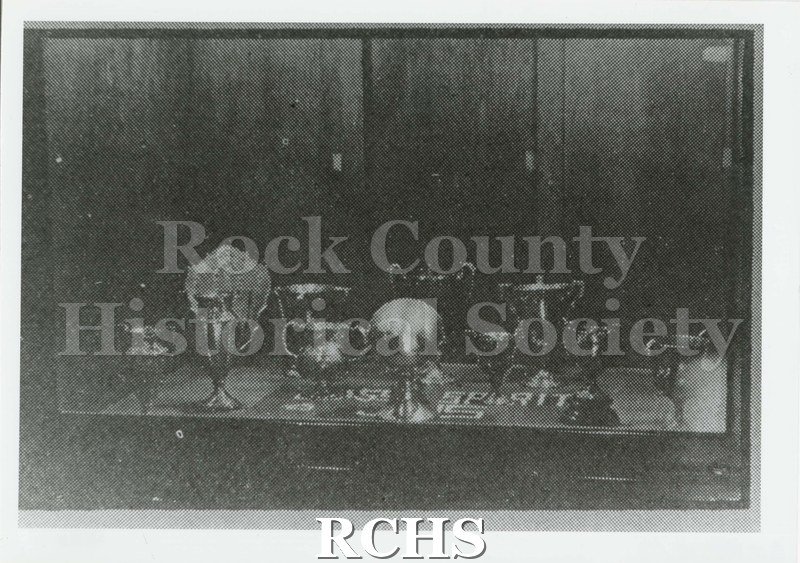 Black and white photograph of the Janesville High School Trophy Case Janesville High School 1924. Written on reverse: "Trophy Case 1924 Phoenix pg.19".