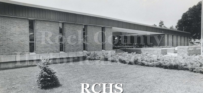 Black and white photograph of the Janesville Public Library shown from the front.