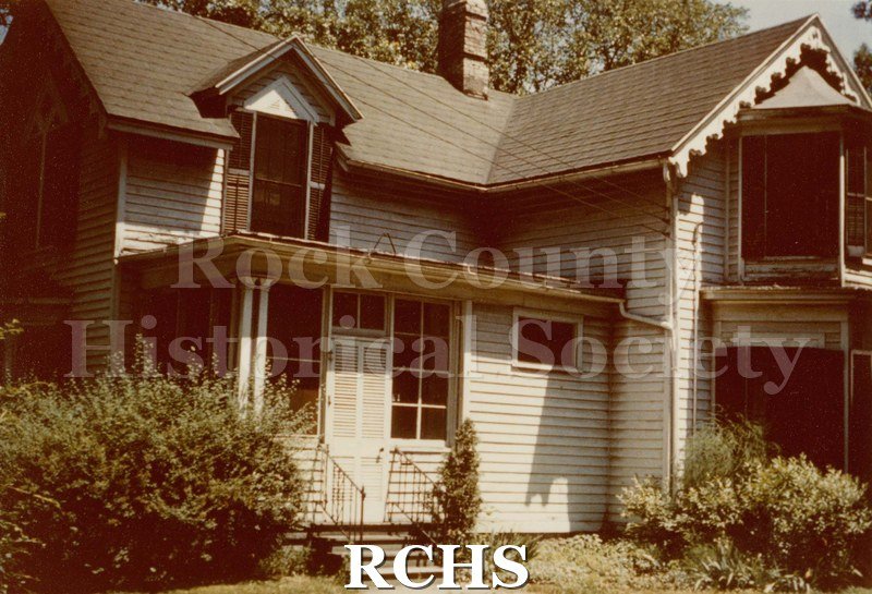 Colored photograph of Porter House, College Avenue, Beloit. Shows a two-storey frame house. Written on reverse: "Porter House 735 College Beloit" "Prof.