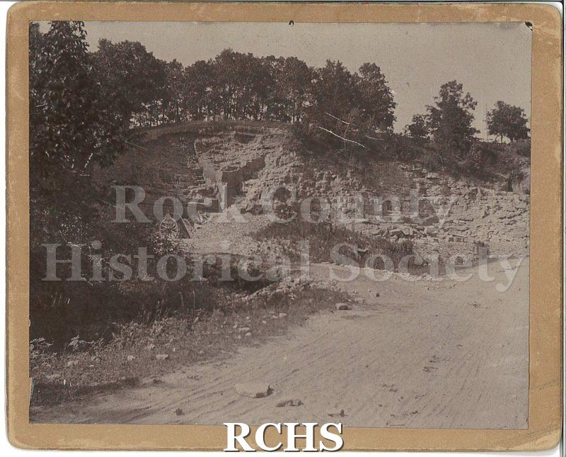Black and white photograph of a stone quarry. Many different inscriptions on back.