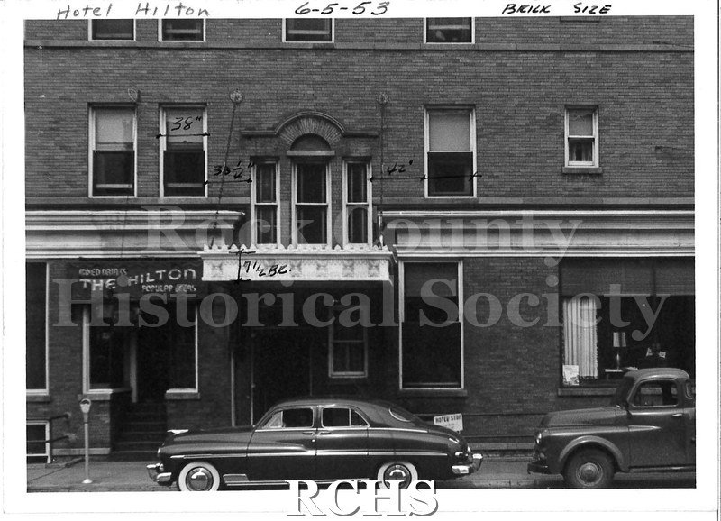 Black and white photograph of Hotel Hilton, Beloit, WI. Shows the facade of the same brick building as in LD36.1990.30.