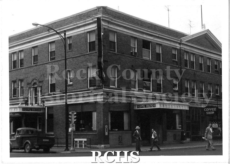 Black and white photograph of Hotel Hilton, Beloit, WI. Shows a corner of the same three story brick building as in LD36.1990.31.