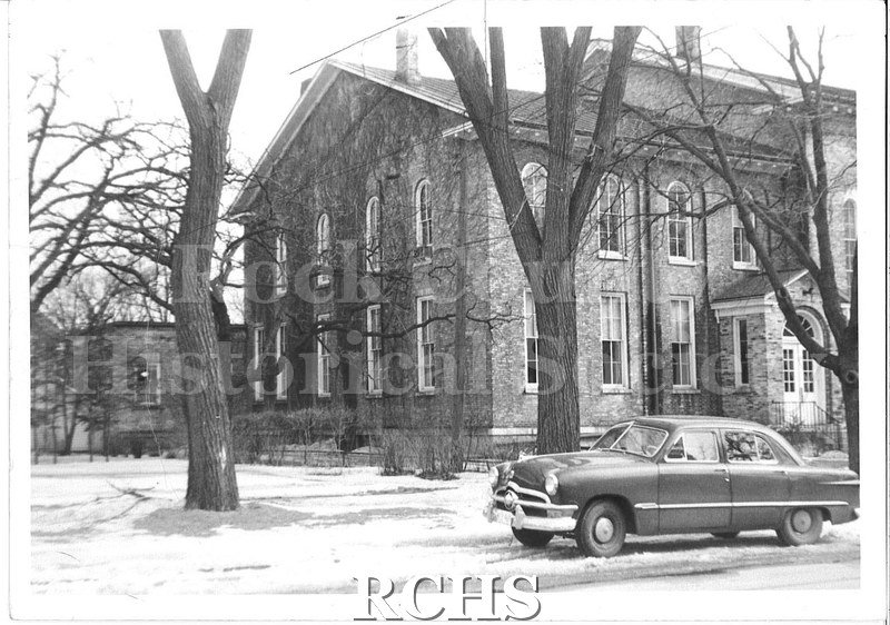 Black and white photograph of the original building of the First Congregational Church in Beloit, WI. This shows part of the back and the left side of the building.