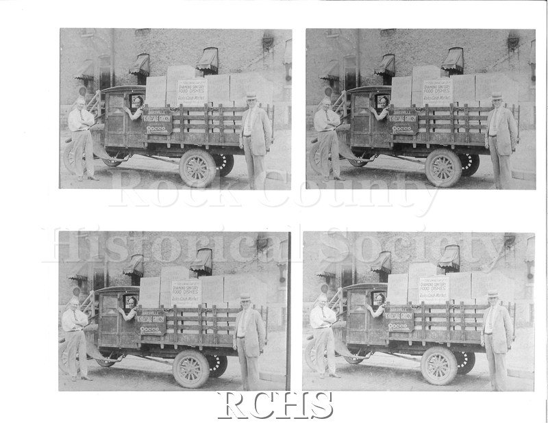 Black and white photograph of a truck for Janesville Wholesale Grocery Company. The truck is parked outside.