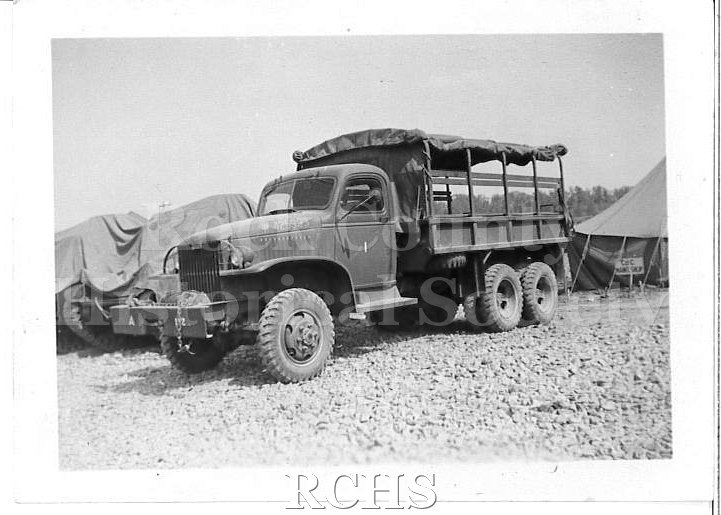 Black and white photograph of WWII Training Fort Knox, KY. GMC cargo truck with canvas cover rolled up, exposing the sides.