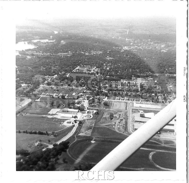 Black and white aerial photo of Janesville, facing west. Rock River is visible in the distance, upper left corner.