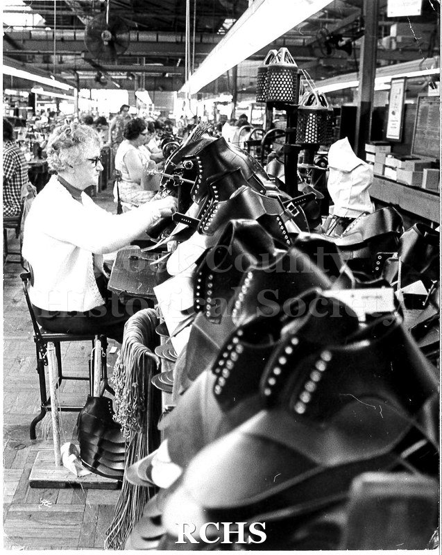 Black and white photograph of a worker at the Edgerton shoe factory.