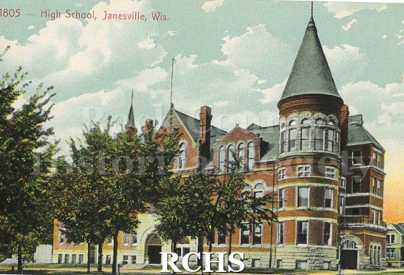 Postcard. Colored image of the Janesville High School building. Image is drawn from the perspective of being across the street.