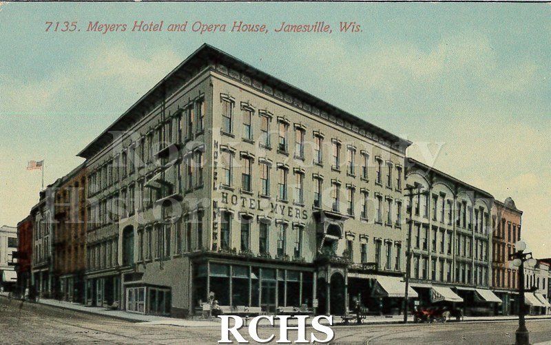 Postcard. Colorized image of the exterior of the Meyers Hotel and Opera House in Janesville.
