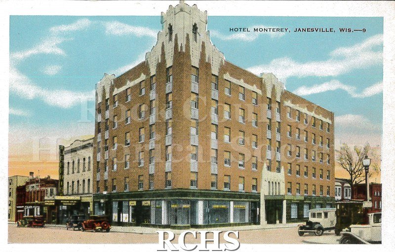 Postcard. Colorized image of the exterior of the Hotel Monterey in Janesville. Jeffirs Theater is visible next door.