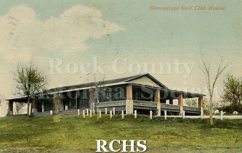 Postcard. Colorized image of the club house at the Sinnissippi Golf Club. Postcard is addressed to Miss Mayme Badeu in Red Wing, MN. Postmarked August 1910.