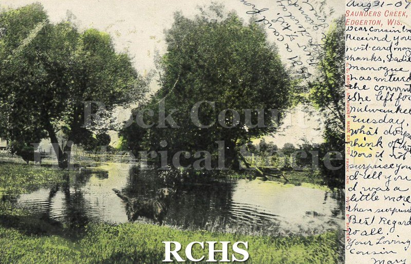 Postcard. Color image of Saunders Creek in Edgerton, Wisconsin. Postcard is addressed to Miss Emily Bier, Janesville. Postmarked August 31, 1907.