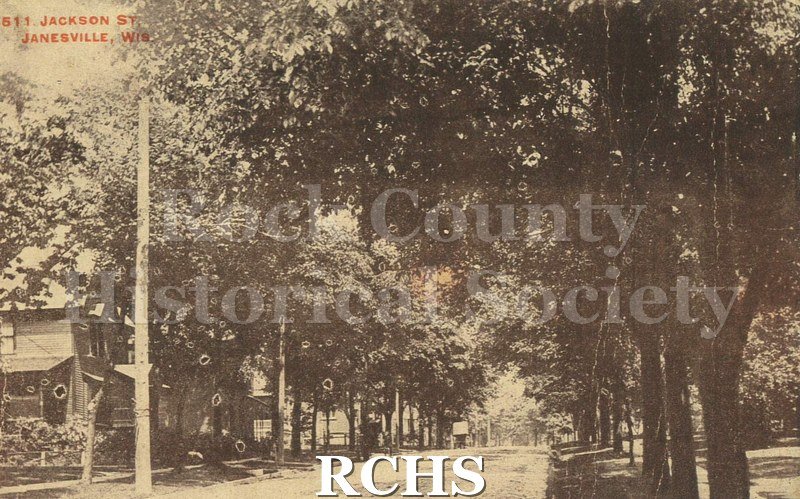 Postcard. Black and white image of Jackson Street in Janesville. Addressed to May Thomas of Milton. Postmarked 16 March 1914.