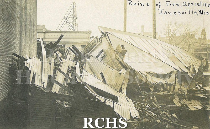 Postcard. Black and white photograph of the ruins following the Milwaukee Street bridge fire in April 1913.