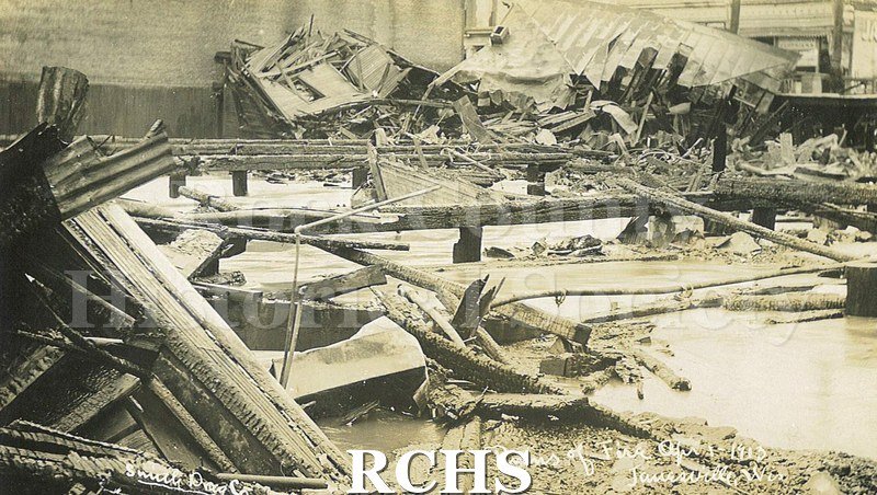 Postcard. Black and white photograph of the wreckage from the Milwaukee Street fire in April 1913.