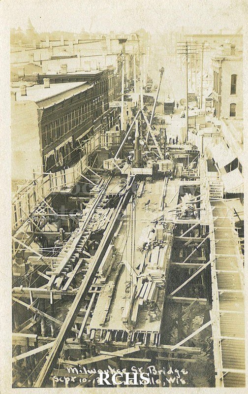 Postcard. Black and white photograph of the Milwaukee Street bridge being repaired after the April 1913 fire.