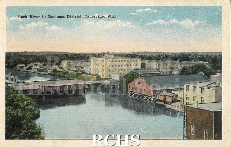 Postcard. Tinted image of downtown Janesville and the Rock River. Addressed to Clara Olson of Evansville. Postmarked 13 March 1917.
