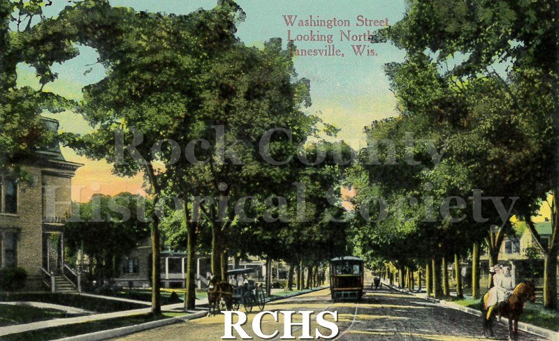 Colored postcard of Washington St. looking north. Addressed to Mr. Ed Lellmer(?) of 313 N. Charles St. Madison, WI.