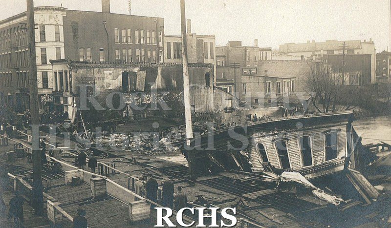 Postcard. Black and white photograph of the aftermath downtown after the Milwaukee Street fire on April 1, 1913.