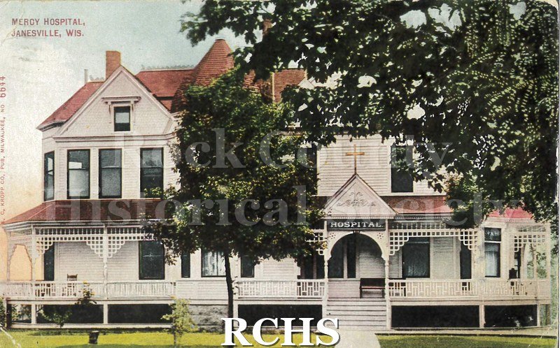 Postcard. Tinted image of Mercy Hospital in Janesville. Addressed to Mrs. D.W. Pepper of Footville. Postmarked 24 January 1914.