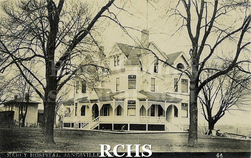 Postcard. Black and white photograph of Mercy Hospital in Janesville. No address or postmark. Extensive message in pencil: "Jan.