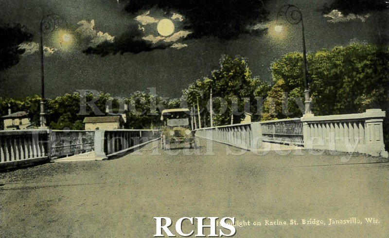 Postcard. Tinted image of the moonlight on the Racine Street bridge in Janesville. Postmarked 30 November 1915 and addressed to Edward Hannafan in Iowa.