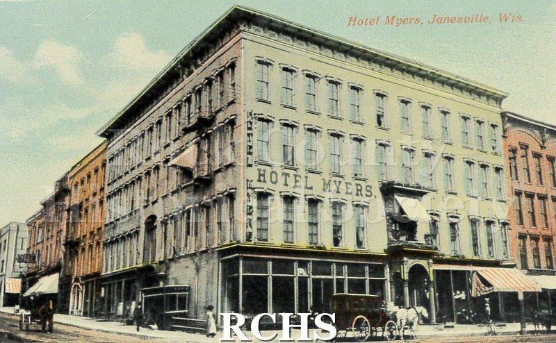 Postcard. Tinted image of the exterior of the Hotel Myers. Pedestrians and carriages are outside the building.