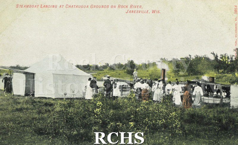 Postcard. Tinted image of individuals waiting for the steamboat to arrive at the Chatauqua Grounds in Janesville.