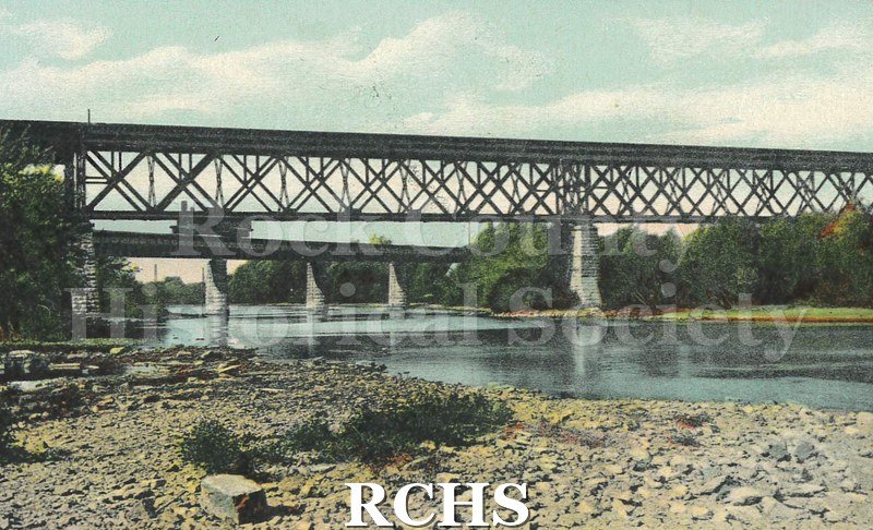 Postcard. Tinted image of a railroad bridge across the Rock River. Addressed to H.C. McLay of Delevan. Postmarked 17 August 1910.