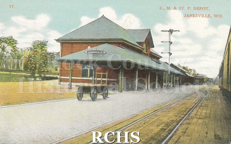 Postcard. Tinted image of the Chicago, Milwaukee & St. Paul depot in Janesville. Addressed to Gertrude Jones of Fond du Lac. Postmarked 8 July 1908.