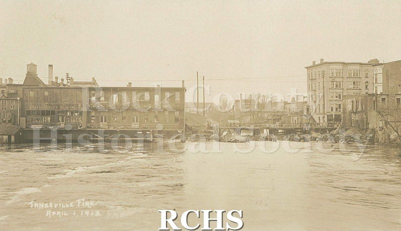 Postcard. Sepia-colored photograph of the ruins following a large fire in downtown Janesville on April 1, 1913.