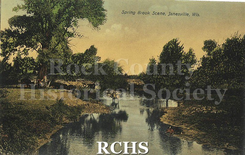 Postcard. Tinted image of a scene near Spring Brook in Janesville. Addressed to Catherine A. McCulloch in Janesville. Postmarked 2 October 1912.