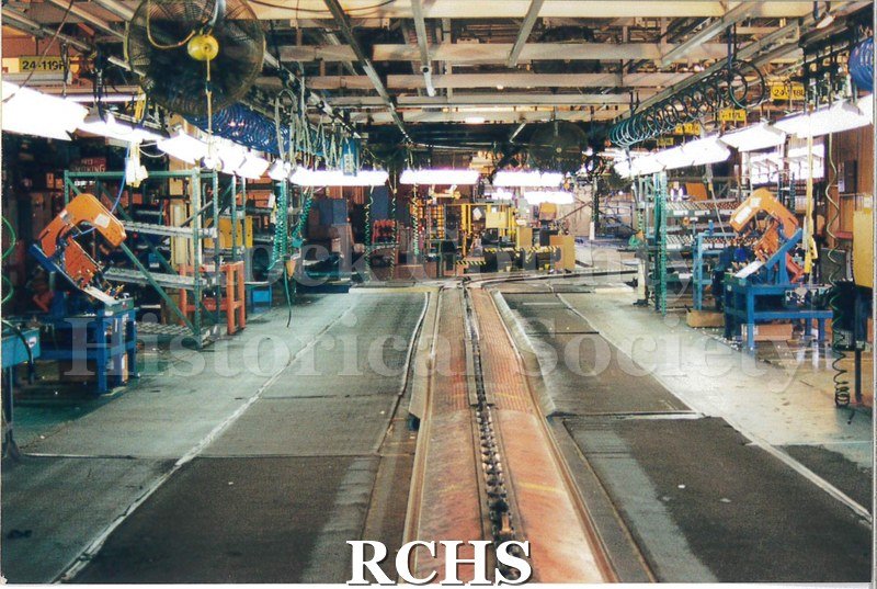 Color photo of the Janesville GM plant assembly line for medium-duty trucks. The line is empty and the workspace around it is clear.