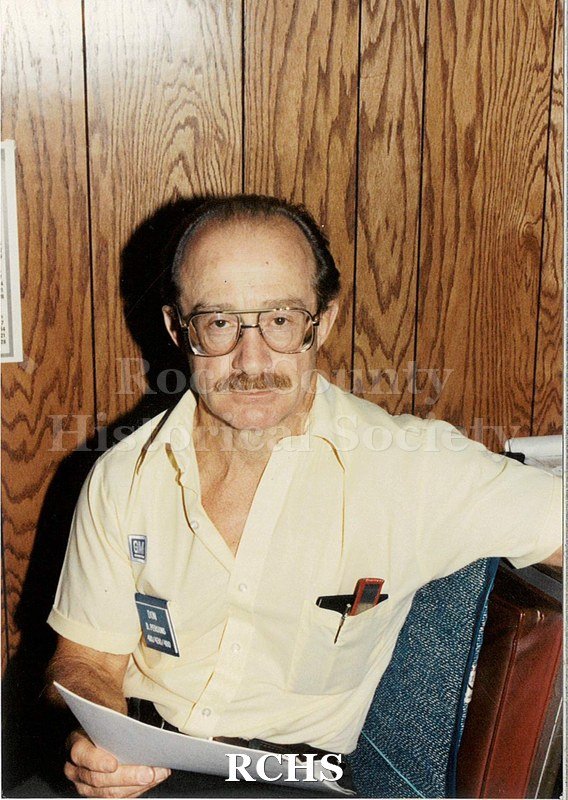 Color photo of an older man, Don Persons, working at Janesville General Motors. He has some brown hair and a mustache.