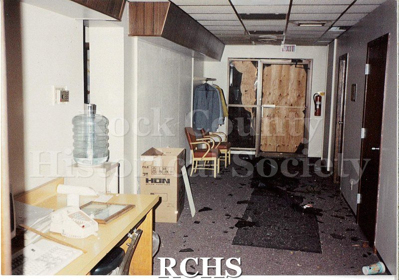 Color photo of the damage to the Janesville Terminal from the 1991 tornado. Shows damage to an office hallway - namely the glass in the exit door is broken.