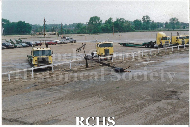 Color photo of the damage to the Janesville Terminal from the 1991 tornado. Shows the outside lot where a few yellow Ryder cabs are parked.