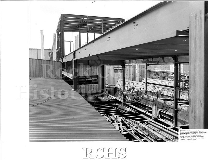 Black and white photograph of men working on a building addition. On bottom: "Alterations-Additions, Janesville Plant, Wis.