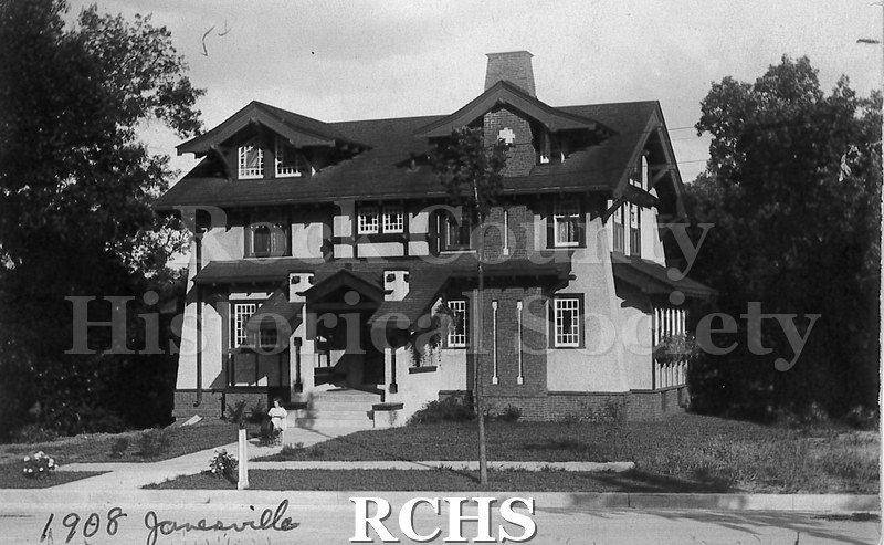 Postcard. Black and white photograph of a house built in Janesville in 1908 by architect Frank H. Kemp in Beloit. Location of home is unknown.