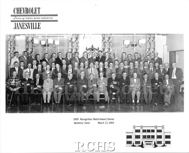 Black and white photograph of Chevrolet employees of Janesville, posed together for the 1959 Recognition Watch-Award Dinner. 65 men are posed in three rows.