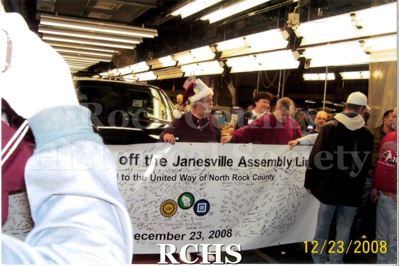 Digital color photo of employees at Janesville General Motors getting ready to pose in front of the last car to be produced at the GM assembly plant.